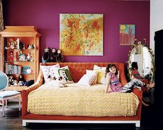 an image of a bedroom with purple walls and yellow bedding in the foreground