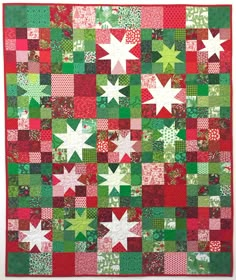 a green and red quilt with white stars on it