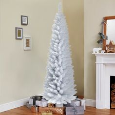 a white christmas tree with presents under it