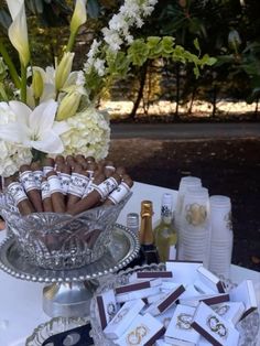 a glass bowl filled with cigars and flowers