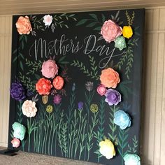 a mother's day sign with flowers on it