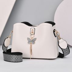 Pu Leather. Crossbody Bag. Various Colors. Semi Structured. Dimensions 23x11x18 Cm. Small Bag. Butterfly Pendant Included. Detachable Strap. Multi Compartment. Tas Bahu, Girly Bags, White Handbag, Fancy Bags, Pretty Bags, Cow Boy, Leather Messenger, Cute Bags, Womens Crossbody Bag