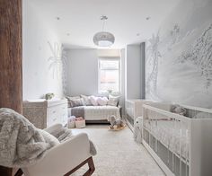 a baby's room is decorated in white and gray