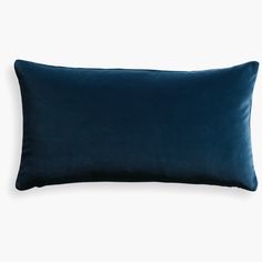 a dark blue velvet pillow on a white background