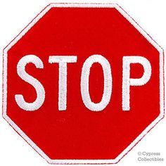 a red stop sign with the word stop written on it's bottom corner in white