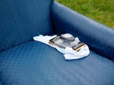 a blue couch with a white towel on it and a computer mouse sitting on top of it