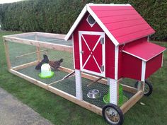 a red chicken coop with two chickens in it and a green bowl on the ground