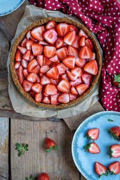 there is a pie with strawberries on the table