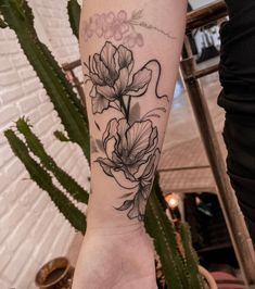 a person with a flower tattoo on their arm