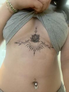 a woman with a lotus tattoo on her stomach