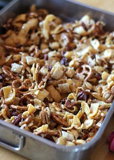 a pan filled with granola sitting on top of a wooden table