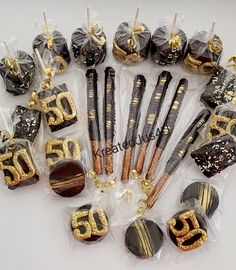 an assortment of chocolates and candies in cello bags with gold numbers on them