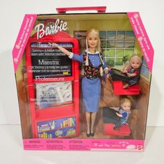 a barbie doll with two babies in it's red and pink box on a white surface