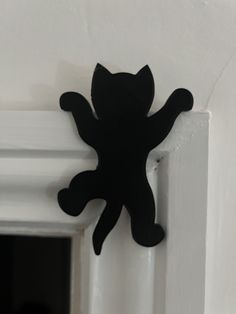 a black cat magnet on the side of a white door