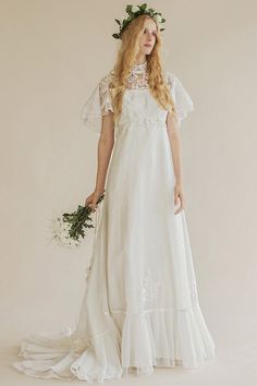 a woman in a white dress holding a bouquet