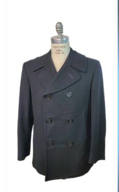 If you are looking for a peacoat, buy a the real deal, here for your consideration is this original US Navy peacoat. Comes with original anchor Navy buttons. Stay warm this fall and protect yourself from the elements this winter while you sport this cool peacoat.  Nice an heavy 100% wool made in United States of America USA. One thing for sure, they don't make them like this anymore. Label reads: Overcoat, Man's, Enlisted, (100% Wool), Contract No. DLA100-90-C-4050, Sterlingwear of Boston, Inc. Classic Black Double-breasted Peacoat, Military Style Pea Coat For Business In Fall, Military Wool Double-breasted Pea Coat, Military Style Wool Pea Coat With Button Closure, Vintage Double-breasted Pea Coat With Double Button Closure, Military Style Formal Pea Coat For Winter, Military Style Formal Winter Pea Coat, Formal Military Pea Coat For Winter, Formal Military Style Winter Pea Coat