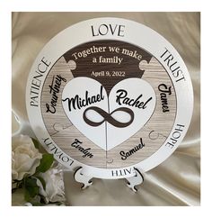 a personalized wooden clock with the names of two people on it and a white rose