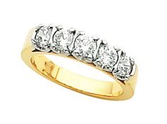 a yellow gold ring with five diamonds