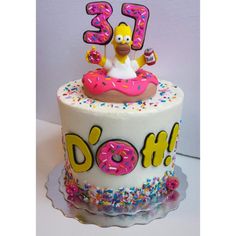 a birthday cake decorated with the simpsons character donuts and sprinkles on top