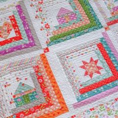 a colorful quilt with many different designs on it