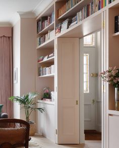 a living room filled with furniture and bookshelves