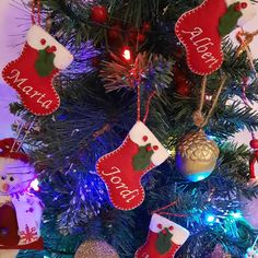 a christmas tree with stockings hanging from it