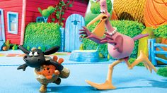 a cartoon character is playing with an animal in front of a red house and blue fence