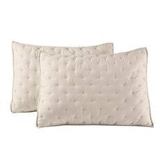 two white pillows sitting next to each other