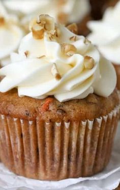 cupcakes with white frosting and nuts on top