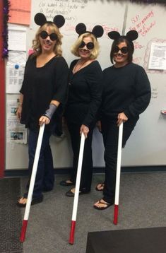 three women dressed up as mickey mouse and minnie mouse