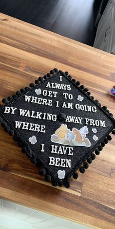 a decorated graduation cap sitting on top of a wooden table