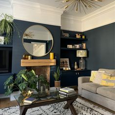 a living room filled with furniture and a large mirror on the wall over a fireplace