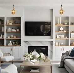 a living room filled with furniture and a flat screen tv mounted on the wall above a fireplace