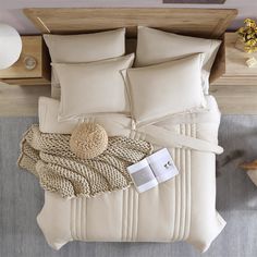 an aerial view of a bed with pillows and blankets