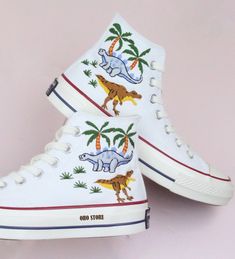 Embroidery converse/Custom Embroidered dinosaur shoes/Custom converse high tops embroidered dinosaur/gift birthday shoes/Personalized name   💸 Price includes Converse Shoes and floral embroidery as shown 🌸 You can send me your Converse/Vans shoes or I can buy them for you. We stock all the Converse and Vans shoes you want, if you want other Converse/Vans shoes in the store, please message us. Your embroidered Converse/Vans shoes will be available for shipping in 7-15 days. 🌸 I started hand embroidering on fashionable clothes and handbags over 20 years ago - and now on CONVERSE/VANS shoes, an American icon, a must-see classic! I'm excited to give your Chuck Taylor shoes a new look with beautiful, nature-inspired embroidery. All images, designs and text used by CUSTOMSHOEDESIGNSOHO are co Casual Sneakers With Custom Embroidery, Casual Custom Embroidery Lace-up Sneakers, Casual High-top Sneakers With Custom Embroidery, Custom Converse High Tops, Embroidered Dinosaur, Embroidery Converse, Converse Fits, Converse Chuck 70s, Dinosaur Shoes