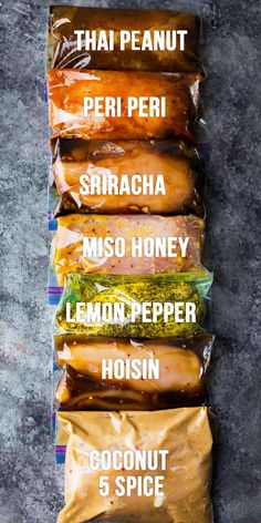 five different types of food wrapped in plastic wrappers on top of each other with the names