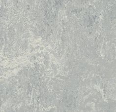 a white marble textured wallpaper with grey and gray streaks on the top right hand corner