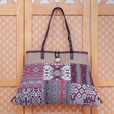 Thai artisan Chirada's gorgeous shoulder bag crafted with pretty patchwork is truly one of a kind. Woven from a poly-cotton blend the bag features lots of contrasting designs and a braided leather handle with matching trim. Inside one zippered pocket and two open pockets give you a place for odds and ends while a dark cotton lining keeps things cushioned. A zippered closure leather button clasp and aluminum bauble finish the bag with thoughtful details. Bohemian Patchwork Cotton Shoulder Bag, Bohemian Cotton Patchwork Shoulder Bag, Bohemian Fabric Travel Bag, Bohemian Travel Bags In Fabric, Bohemian Multicolor Canvas Bag, Patchwork Canvas Shoulder Bag For Travel, Bohemian Fabric Shoulder Bag For Travel, Rectangular Woven Canvas Shoulder Bag, Bohemian Fabric Tote Bag