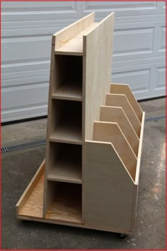 a wooden shelf with several compartments in front of a garage door