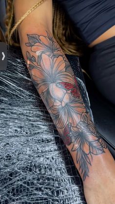 a woman's arm with flowers on it