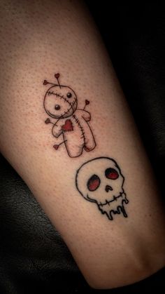 a person with a tattoo on their leg has a skull and a teddy bear in it