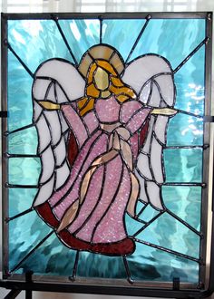 a stained glass window with an angel on it