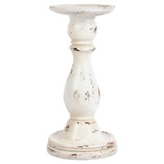 an old white candle holder is shown on a white background with no one around it