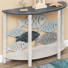 a console table with fish cutouts on the top, and a bird figurine sitting on top