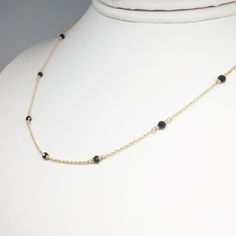 This necklace is handmade with 7 genuine Black Spinel Gemstones wrapped in 14k Gold Filled or Sterling Silver, length of your choice. This dainty necklace is easy to wear alone or layered with other necklaces. All of our jewelry is handmade in our New York studio and every gemstone is handpicked to ensure the highest of quality. Item Description: - 7 Genuine Spinel (3.0 mm) - USA made 14k Gold Filled or Sterling Silver (Nickel Free) - Length imaged: 15 inches *Note* If length you would like to c Simple Gold Necklace, Black Spinel Necklace, Spinel Necklace, Make Fashion, Gemstone Choker, Gold Necklace Simple, Spinel Gemstone, Handmade Beaded Necklaces, August Birthstone