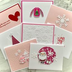 christmas cards with santa claus and snowflakes on them, all handmade by the same person