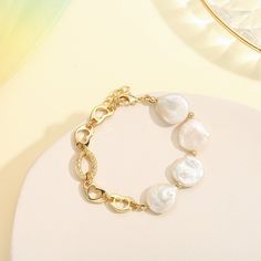 This exquisite Pearl Hollow Chain Bracelet will accessorize any outfit with timeless elegance. Crafted from 18k gold and delicate pearl chains, this bracelet exudes sophistication and style, making it the perfect addition to any luxury ensemble. DETAILS Plating: 18k Gold on Brass Materials:   18K Gold on Brass, Freshwater Pearl Measurements: Length: 6.30"(16.0cm) + Extender: 1.97"(5.0cm) Weight:  13.27g Note: It will be in stock in 7 business days! Gold Pearl Charm Chain Bracelet, Gold Pearl Bracelet With Adjustable Chain, Elegant Baroque Pearl Bracelet Jewelry, Gold Metal Pearl Bracelet With Pearl Charm, Gold Pearl Bracelet With Metal Charm, Gold-plated Pearl Chain Bracelet, Gold Plated Pearl Chain Bracelet Gift, Gold Plated Pearl Chain Bracelet As Gift, Gold Pearl Bracelet With Chain