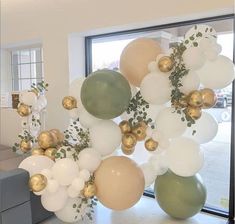 balloons and greenery are hanging from the ceiling