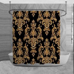 a black and gold shower curtain with an ornate design on the front in a bathroom