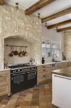 a kitchen with an oven, stove and counter tops in stone walled walling area